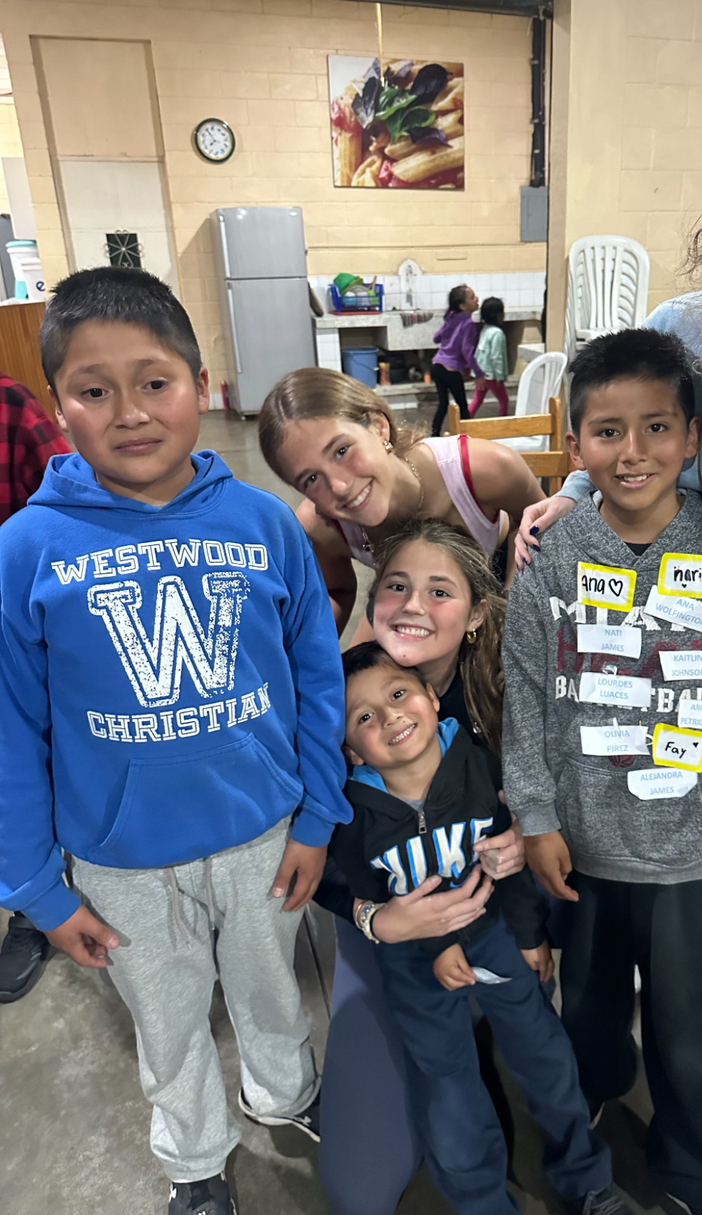 Ana Wolfington and Isabella Wolfington with children during service work